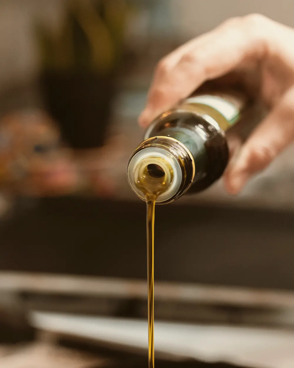 Golden vegetable oil poured in a fine stream